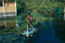 A young man brings his water filter to a higher ground 