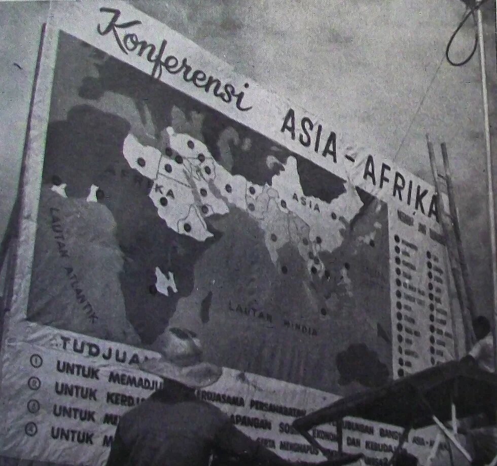 Asian-African Conference Bulletin, No. 9. April 25, 1955; published by the Indonesian Ministry of Information: "A "Betjak” driver reads one of the Conference posters." 