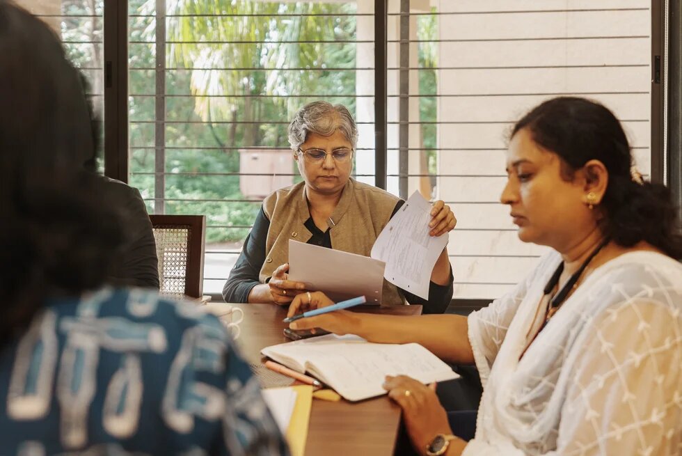 Priyadarshini Karve during a curriculum planning meeting at a university.